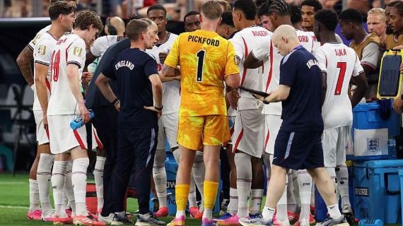 A photo of the England team in a huddle during a hydration break at their recent World Cup game